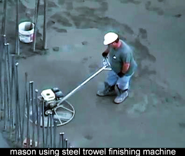 using a mechanical steel trowel to finish floor slab